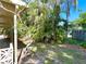 Home's backyard view with tropical foliage and a small corner of a fence at 103 Oakwood Blvd, Sarasota, FL 34237