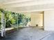 Under the carport is a large, paved area with storage and access to the yard, providing space for hobbies at 103 Oakwood Blvd, Sarasota, FL 34237