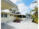 Exterior of home with a cozy, screened-in porch and a spacious carport, perfect for outdoor living at 103 Oakwood Blvd, Sarasota, FL 34237