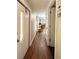 Hallway with wood floors leading to the kitchen and other rooms at 103 Oakwood Blvd, Sarasota, FL 34237