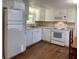 White kitchen cabinets and appliances, laminate floors at 103 Oakwood Blvd, Sarasota, FL 34237
