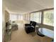 Bright sunroom with carpet, multiple windows with blinds and comfortable seating at 103 Oakwood Blvd, Sarasota, FL 34237