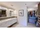 Modern bathroom with double vanity, a large mirror, and a walk-in closet at 114 Tidy Island Blvd, Bradenton, FL 34210