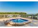 Relaxing hot tub with surrounding seating area and water views at 114 Tidy Island Blvd, Bradenton, FL 34210