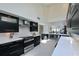 Modern kitchen featuring sleek black cabinetry, stainless steel appliances, and an open layout at 114 Tidy Island Blvd, Bradenton, FL 34210