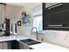 Modern kitchen with white quartz countertops and dark cabinetry, a farmhouse sink at 114 Tidy Island Blvd, Bradenton, FL 34210