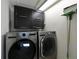 Laundry room with LG washer and dryer and dark brown cabinets at 114 Tidy Island Blvd, Bradenton, FL 34210