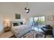 Bright main bedroom with private balcony and serene water views at 114 Tidy Island Blvd, Bradenton, FL 34210