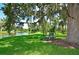 Serene waterfront park bench under a large oak tree at 114 Tidy Island Blvd, Bradenton, FL 34210