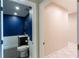 Powder room featuring dark blue walls, wainscotting, a vessel sink, and attractive fixtures at 13634 7Th Avenue Ne Cir, Bradenton, FL 34212
