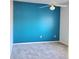 Bedroom with teal accent wall and neutral carpeting at 13634 7Th Avenue Ne Cir, Bradenton, FL 34212