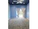 Comfortable bedroom with blue walls, carpet flooring, and a sliding door to the outdoors at 13634 7Th Avenue Ne Cir, Bradenton, FL 34212