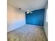 Bright bedroom with gray carpet, blue accent wall, and ceiling fan at 13634 7Th Avenue Ne Cir, Bradenton, FL 34212