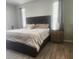 Comfortable bedroom with a plush bed, soft lighting, and stylish wood-look floors at 13634 7Th Avenue Ne Cir, Bradenton, FL 34212