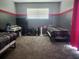 Bedroom with twin beds, carpet floors, and a gray and red accent wall at 13634 7Th Avenue Ne Cir, Bradenton, FL 34212