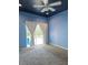 Bedroom with ceiling fan, carpet flooring, blue walls and curtains, and sliding door at 13634 7Th Avenue Ne Cir, Bradenton, FL 34212