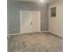 Neutral bedroom features plush gray carpet, a double french door, and a window with blinds at 13634 7Th Avenue Ne Cir, Bradenton, FL 34212