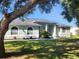 Charming single-story home featuring a well-maintained lawn, light green exterior, and a welcoming front entrance at 13634 7Th Avenue Ne Cir, Bradenton, FL 34212