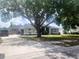 Charming single-story home featuring a well-maintained lawn, light green exterior, driveway and a two-car garage at 13634 7Th Avenue Ne Cir, Bradenton, FL 34212