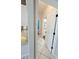 Tile hallway showing access to bathrooms with modern features and granite countertops at 13634 7Th Avenue Ne Cir, Bradenton, FL 34212