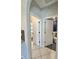 Hallway with tile floors leading to bathrooms featuring modern fixtures and finishes at 13634 7Th Avenue Ne Cir, Bradenton, FL 34212