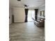 Bright living room with hardwood floors and sliding glass doors that lead to the pool at 13634 7Th Avenue Ne Cir, Bradenton, FL 34212