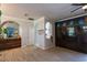 Open-concept living room featuring unique decor, arches, and wood-look tile flooring at 13634 7Th Avenue Ne Cir, Bradenton, FL 34212