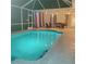 Inviting covered and screened pool with underwater lights and poolside seating for nighttime enjoyment at 13634 7Th Avenue Ne Cir, Bradenton, FL 34212