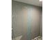 Stylish bathroom shower featuring textured grey wall tiles with a blue accent stripe at 13634 7Th Avenue Ne Cir, Bradenton, FL 34212