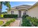 Welcoming entryway with brick path and lush landscaping at 14706 5Th Ne Ter, Bradenton, FL 34212