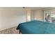 Bedroom with teal comforter and access to backyard patio at 1477 Dogwood Dr, Sarasota, FL 34232