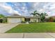 Inviting single-story home with a landscaped yard and attached garage at 1477 Dogwood Dr, Sarasota, FL 34232