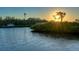 Tranquil waterfront view at sunset, showcasing calm waters and lush vegetation at 1862 Island Way, Osprey, FL 34229