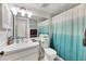 Clean bathroom with updated fixtures, a vanity with ample counter space, and a shower with teal curtain at 2124 N Tamiami Trl # 103, Sarasota, FL 34234