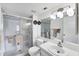 Bathroom featuring glass-door shower, sink and large mirror at 2124 N Tamiami Trl # 103, Sarasota, FL 34234
