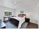 Bedroom with a ceiling fan, window, and bedside tables and lamps at 2124 N Tamiami Trl # 103, Sarasota, FL 34234