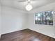 Bright bedroom featuring wood floors, a ceiling fan, and a window with a peaceful view at 2124 N Tamiami Trl # 103, Sarasota, FL 34234
