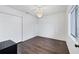 Empty bedroom with ceiling fan, window, and wood floors at 2124 N Tamiami Trl # 103, Sarasota, FL 34234