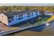 Exterior view features the building, parking area, canal, and boat slip, offering easy access to the waterfront at 2124 N Tamiami Trl # 103, Sarasota, FL 34234