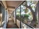 Bright hallway with a large tree view through screen, neutral carpet, and easy access to outdoor surroundings at 2124 N Tamiami Trl # 103, Sarasota, FL 34234
