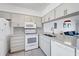 Modern kitchen featuring white appliances, ample cabinet space, and a functional layout for cooking and entertaining at 2124 N Tamiami Trl # 103, Sarasota, FL 34234