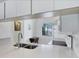 Bright kitchen with stainless steel sink, white quartz countertops, and a view through the window at 2124 N Tamiami Trl # 103, Sarasota, FL 34234