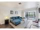 Comfortable living area with a sectional sofa and sliding glass doors leading to a balcony with a natural view at 2124 N Tamiami Trl # 103, Sarasota, FL 34234