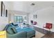 Cozy living room featuring stylish decor, an open layout, and balcony access for indoor-outdoor living at 2124 N Tamiami Trl # 103, Sarasota, FL 34234