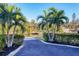 Palm-lined walkway leading to a dock, featuring a tranquil waterfront view at 2124 N Tamiami Trl # 103, Sarasota, FL 34234