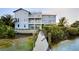 Private backyard with a wooden dock leading to the water at 2516 Avenue A, Bradenton Beach, FL 34217
