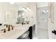 Elegant bathroom with dual sinks, a large mirror, and a walk-in shower at 2516 Avenue A, Bradenton Beach, FL 34217