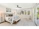 Spacious main bedroom with light flooring, large windows, and a comfy bed at 2516 Avenue A, Bradenton Beach, FL 34217