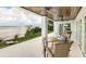 Waterfront patio with outdoor seating and cornhole game at 2516 Avenue A, Bradenton Beach, FL 34217
