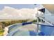 Inviting infinity pool and spa overlooking the water at 2516 Avenue A, Bradenton Beach, FL 34217